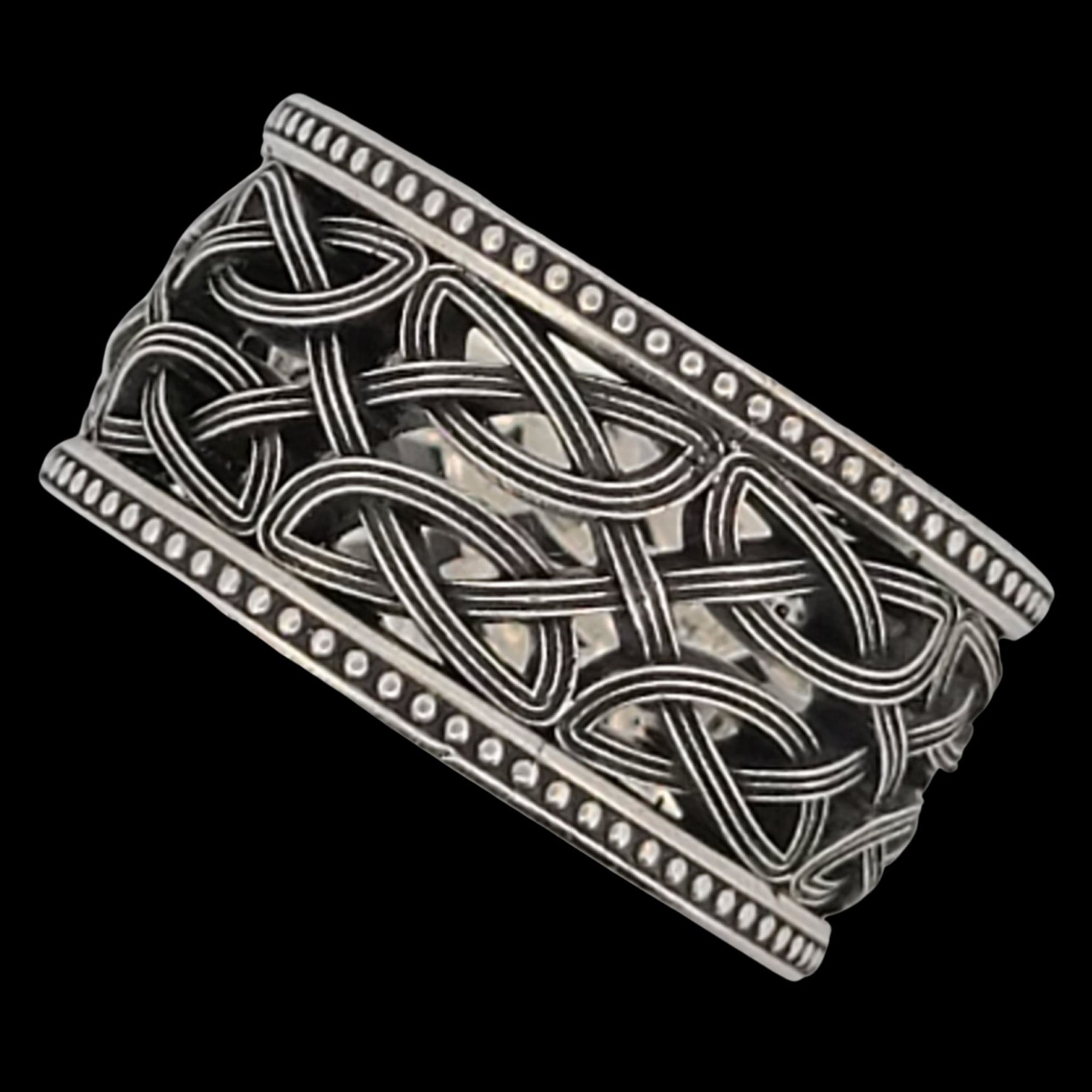 a silver ring with an intricate design on it