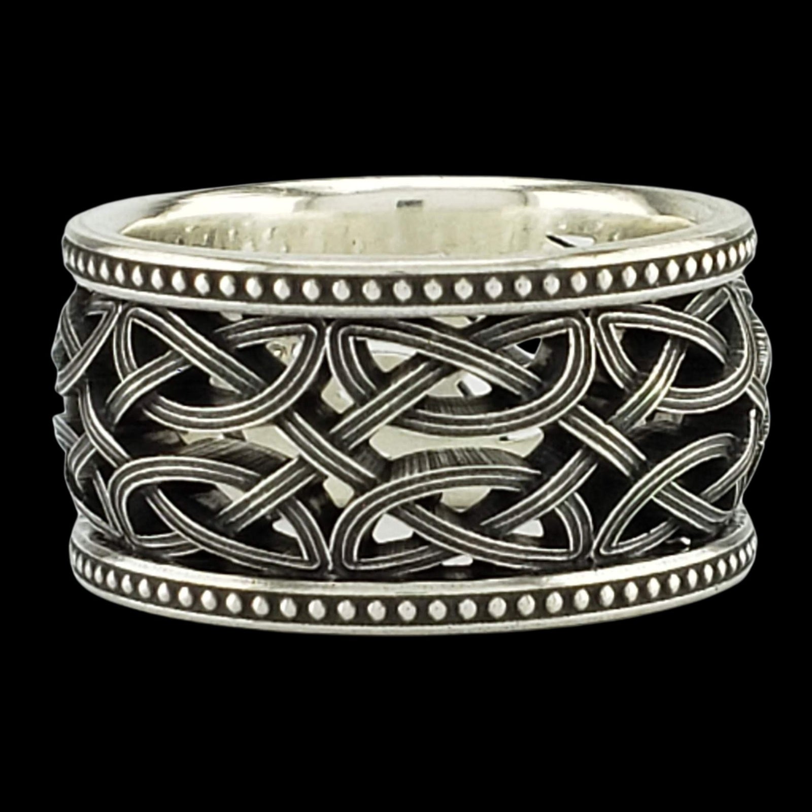 a silver ring with an intricate design