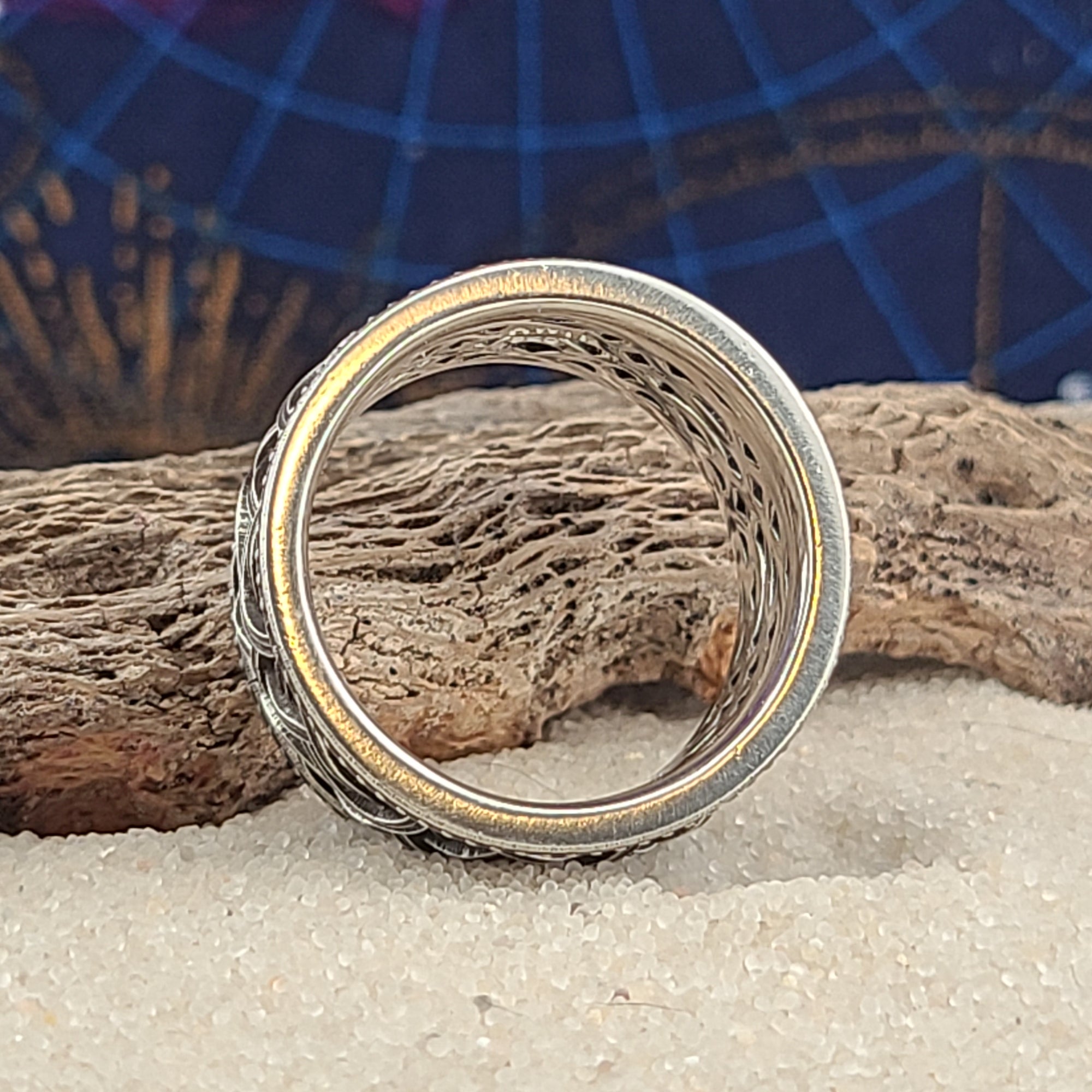 a close up of a ring on a piece of wood